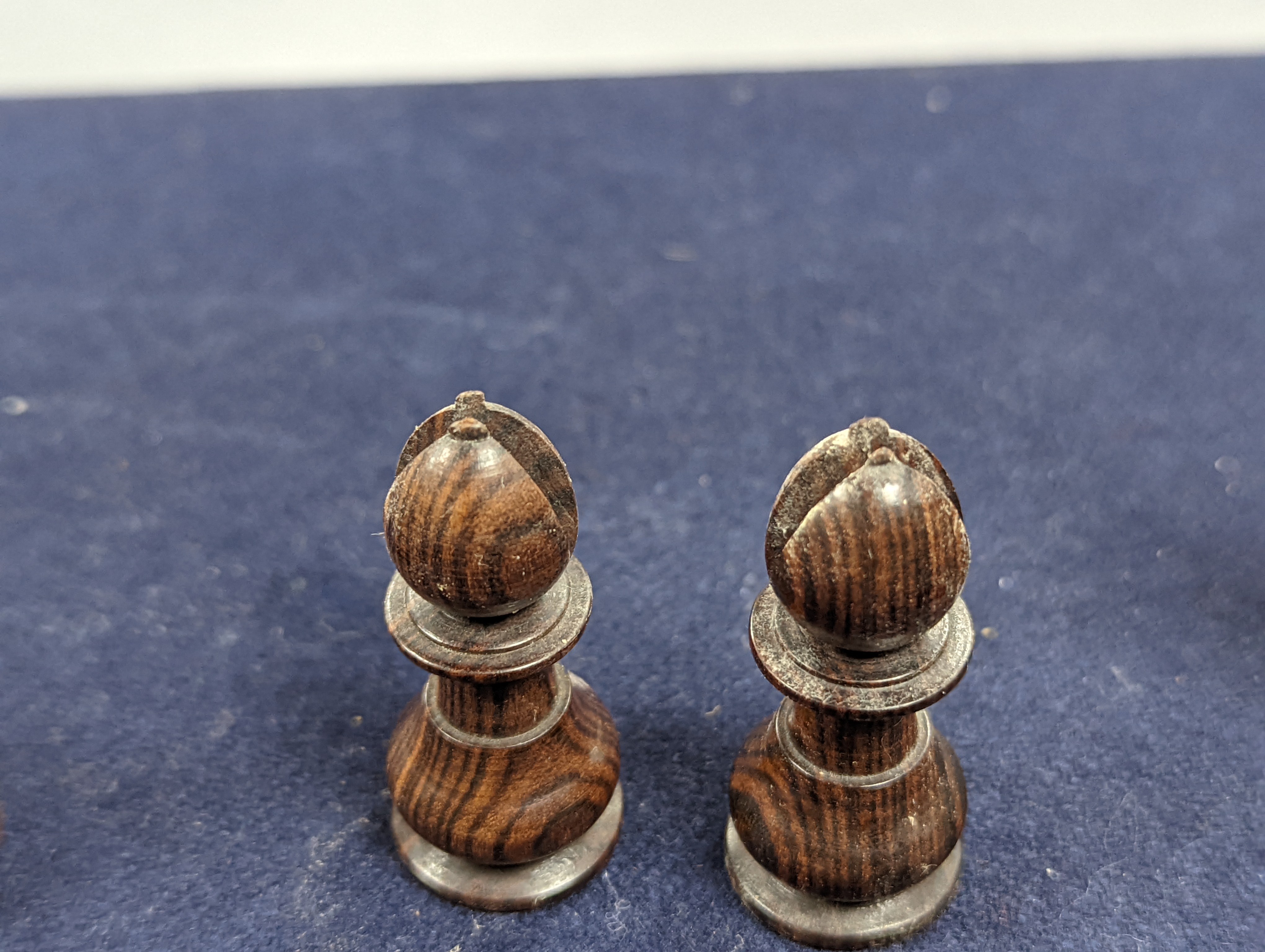 A Victorian brass inset mahogany games box, fitted with solitaire, cribbage, chessmen, draughts etc., 33cm, a turned and stained bone chess set, another games box containing chessmen and draughts